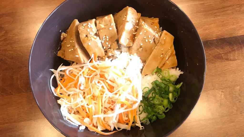 Tofu Teriyaki Rice · Vegetarian. Steamed and fried tofu over jasmine rice served with house teriyaki sauce topped with bok choy, corn, seasoned carrot and cabbage, sesame seeds, and scallion.
