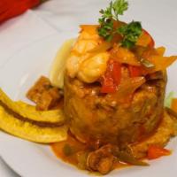 Mofongo Dominicano De Camaron Y Cerdo · Mashed green plantains with shrimp and pork served with creole sauce (Dominican).