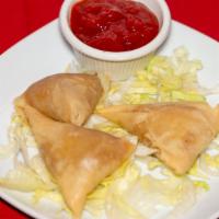 Chicken Samosa · Two pieces pastry stuffed with ground chicken and peas.