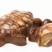 Yellow Turtle · Milk chocolate with Signature butter caramel and toasted cashew.