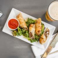 Cheesesteak Spring Rolls · Thinly sliced ribeye, caramelized onions, American cheese, served with sriracha ketchup.