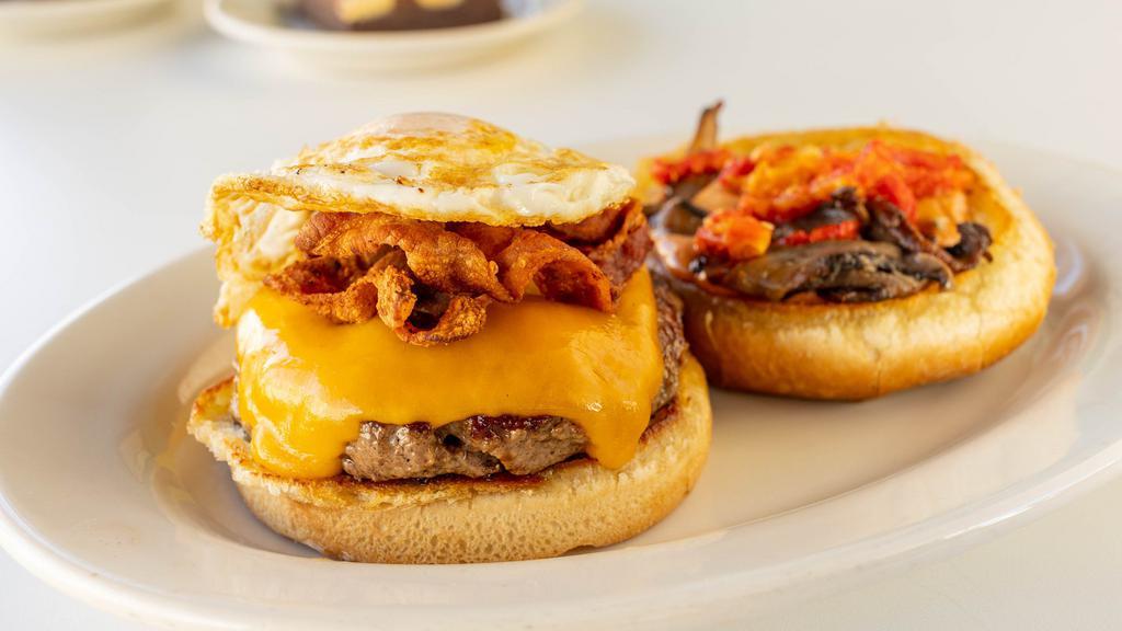 Umami Burger · 100% Angus beef topped with pecan smoked bacon, roasted portabella mushrooms, sun-dried tomato confit, smoked cheddar, over easy egg and umami mayo.