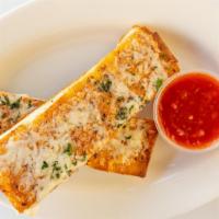 Garlic And Asiago Cheese Bread · House-made flatbread topped with garlic butter, parsley, shredded asiago, romano, fontina an...