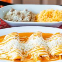 Enchiladas · Su elección de pollo o queso, crema agria y queso, servido con arroz y frijoles / Your choic...