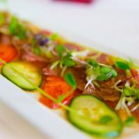 Kobe Beef Carpaccio · 6 pieces seared with hot olive oil, ginger, garlic, scallions, served with citrus ponzu sauce