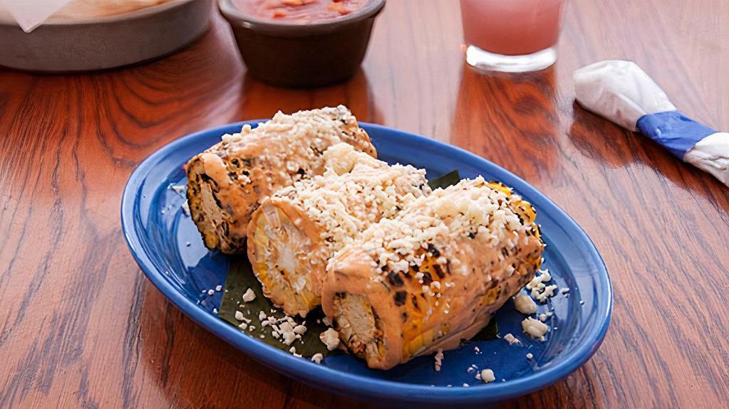 Mexican Street Corn · Grilled corn on the cob, just like from the streets of Mexico. Topped with chipotle aioli and queso fresco.