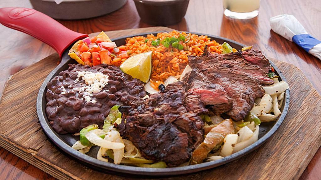 Original Grilled Fajitas · Served on a bed of seasoned onions and peppers with Mexican rice and beans, sour cream, guacamole, lettuce, tomatoes, cheese, and warm tortillas.