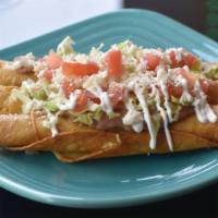 Flautas · Three crispy corn rolled tortillas with your choice of filling topped with refried beans, le...
