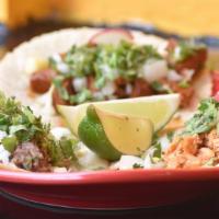 Beantown Tacos · Three soft corn tortillas with your choice of filling, topped with onions and cilantro.