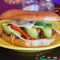 Torta · Mexican style sandwich stuffed with your choice of filling, refried beans, cheese, onions, p...