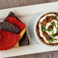 Burnt End Chili  · Smoked brisket and pulled pork chili topped with sour cream and scallions and served with co...