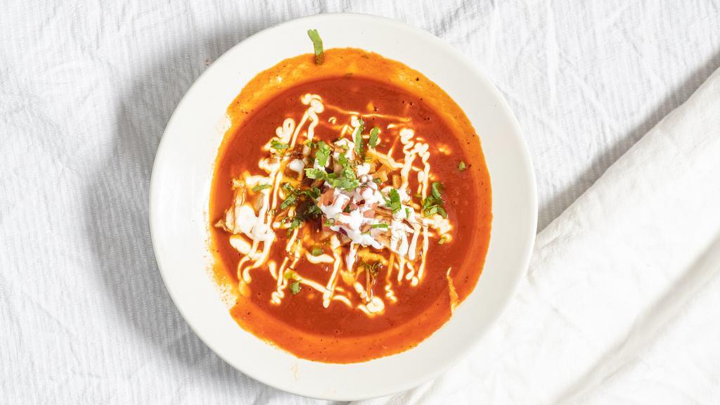 Chicken Tortilla Soup · Tomato-based soup with pulled chicken, spices, cheese, sour cream, cilantro, and tortilla strips.