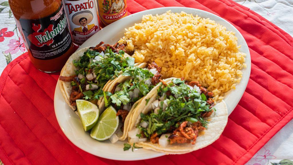 Homemade Tacos · 3 soft tacos made with corn tortillas filled with your choice of 1 meat. Pick Mexican style with cilantro and onions or American style with lettuce, tomato, and cheese. Served with choice of side, rice or beans.