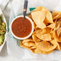 Combo. · Guacamole with a container of salsa and a small bag of chips.