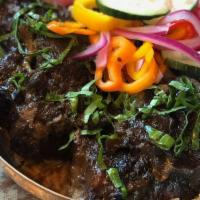 Oxtails Bowl · Oxtails over jasmine rice, cucumber salad