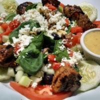 Baby Spinach Salad · Spinach, walnut, Feta cheese, black olives, tomatoes, white dressing and cucumber.