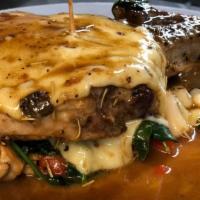 Stuffed Pork Chops · Grilled pork chops with sautéed roasted red peppers, spinach topped with mozzarella in a mar...