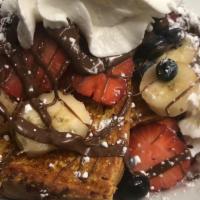 French Toast Supreme · French toast supreme topped with seasonal fruits (strawberry, banana, blueberries) drizzled ...