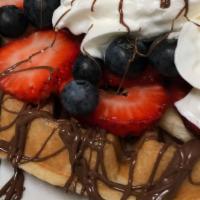 Waffle Supreme · Topped with seasonal fruits (strawberry, banana, blueberries) drizzled with nutella and whip...