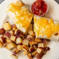Breakfast Burrito · Three eggs scrambled with onions, sausage and jalapenos wrapped in a flour tortilla and topp...