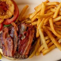 Texas Burger · 8 oz. angus beef burger with lettuce, tomato, bacon, and BBQ sauce topped with onion rings.