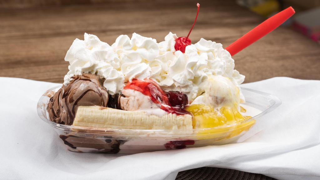 Banana Split · Three scoops of any ice cream flavor. Drizzled with pineapple and strawberry sauce and topped with whipped cream and a cherry.