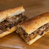 Og Cheesesteak Sandwich · Halal ribeye, caramelized onions, cooper sharp cheese, on a toasted artisan Italian seeded r...