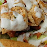 Grilled Chicken Caesar Salad · Crisp romaine lettuce with tomato, croutons, and grated cheese, topped with our creamy Caesa...