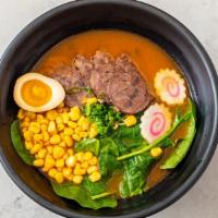 Beef Ramen · Tomato broth, ramen with sliced beef, baby spinach, marinated soft boiled egg, corn, fish ca...