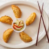 Curry Puff · Crispy shell stuffed with curry seasoned chicken, potatoes, onions and carrots served with c...