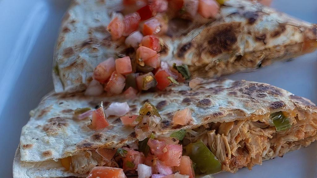 Grilled Chicken Quesadilla · Crispy flour tortilla stuffed with cheddar-jack cheese, grilled chicken, peppers, onions and served with salsa and sour . cream. Topped with pico de gallo.
