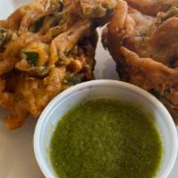 Vegetable Pakora · Vegan, nut free, dairy free. 5 pieces of spinach, onion, potato fritters and served with chu...