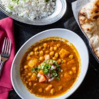 Aloo Chole · Vegetarian. Chickpeas cooked with potatoes, tomatoes, and exotic spices. Served with fragran...