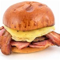 Meat Lover'S Brioche · Sage sausage, Applewood smoked bacon, carved signature ham, a freshly cracked egg, and aged ...
