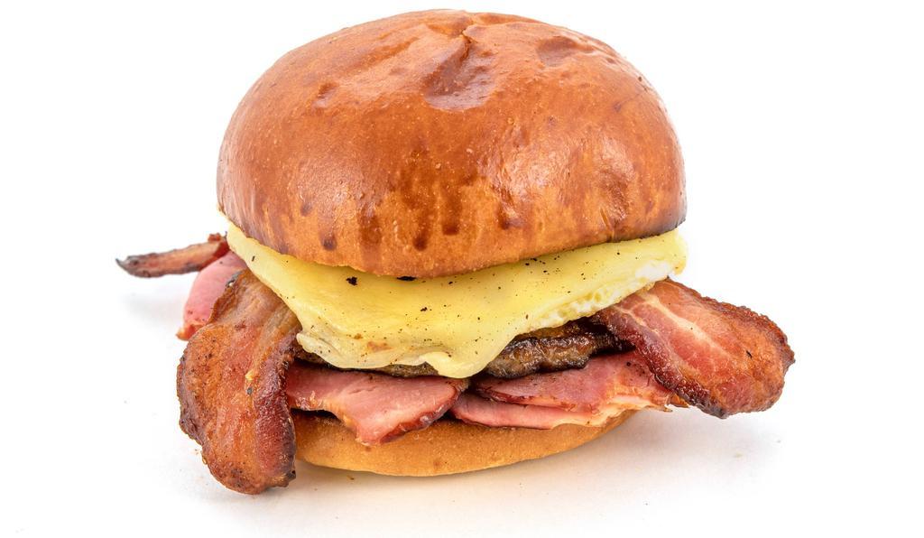 Meat Lover'S Brioche · Sage sausage, Applewood smoked bacon, carved signature ham, a freshly cracked egg, and aged Vermont white cheddar on a brioche bun.