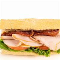 Turkey Club Baguette · Oven-roasted turkey breast, Applewood smoked bacon, lettuce, tomato, mayo, and aged Vermont ...