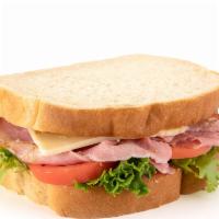 Ham & Swiss On Sourdough · Carved signature ham, Swiss cheese, creamy whole grain mustard, lettuce, and tomato on sourd...