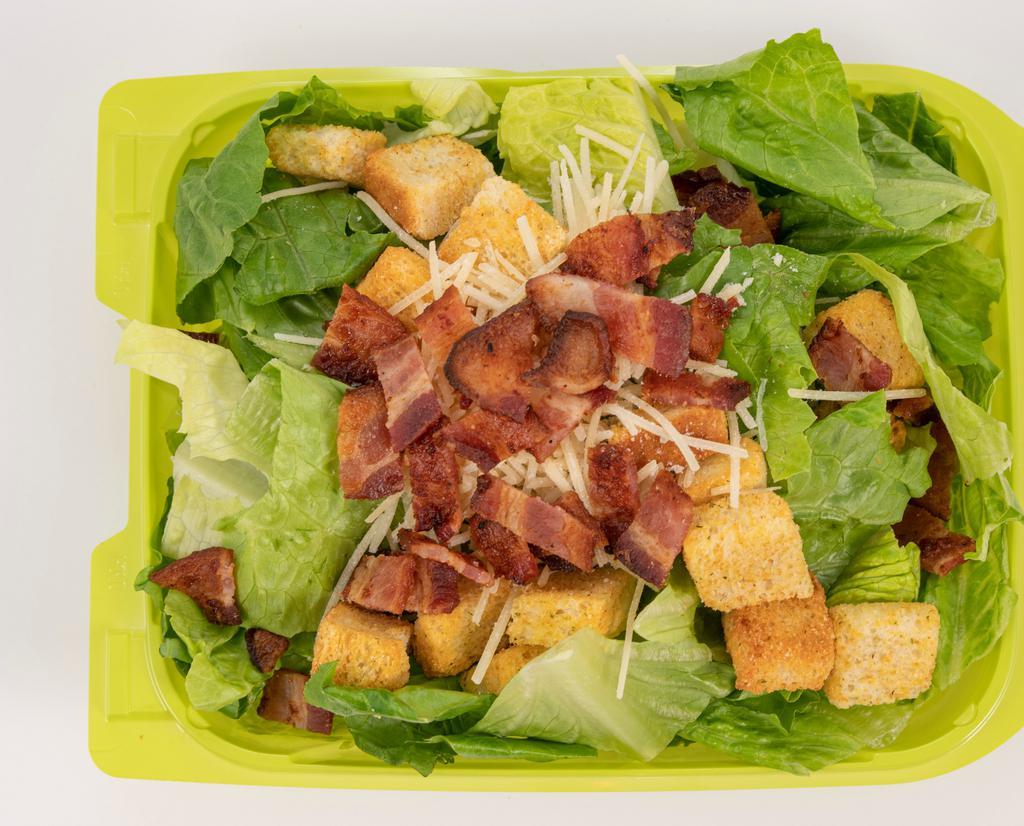 Caesar Salad · Fresh Romaine lettuce topped with chopped bacon, parmesan, crunchy croutons, and creamy Caesar dressing.
