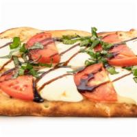 Caprese · Pizza sauce, sliced fresh mozzarella, tomato, and basil, drizzled with balsamic reduction.