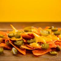 Nachos With Cheese, Jalapeños · Chips with cheese and a variety of toppings.