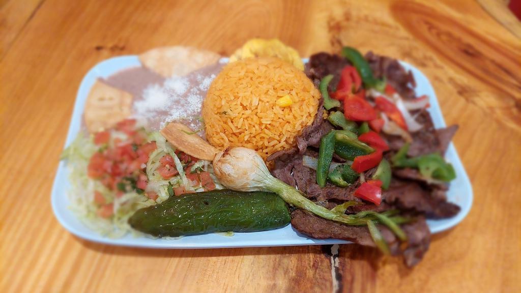 Carne Asada · Bistec, arroz, frijoles, ensalada, and tortillas. / Grilled steak, rice, beans, salad, and tortillas.