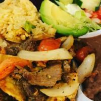 Fajita · Sautéed steak strips or chicken with green peppers, tomatoes and onions. Served with rice, b...