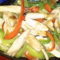 Fajitas De Pollo · Chicken fajitas served on a sizzling plate with red and green peppers, onions, mushrooms, ri...