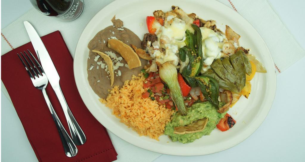 Alambre Iztaccihuatl · Baby shrimp, chicken, steak, onions, red and green peppers served with rice, beans, pico de gallo, guacamole, cactus, onions, oaxaca cheese and queso fresco.