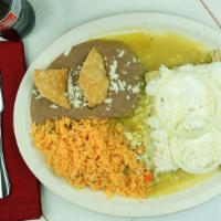 Enchiladas De Mole · 15 pieces soft corn tortillas filled with chicken, covered in mole sauce, topped with fresh ...