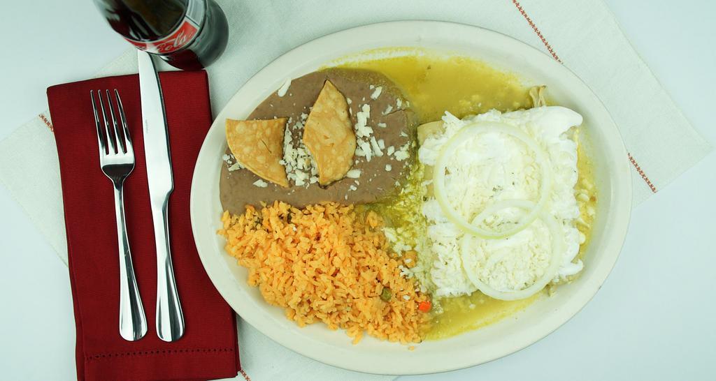 Enchiladas De Mole · 15 pieces soft corn tortillas filled with chicken, covered in mole sauce, topped with fresh cheese, onions and sour cream.