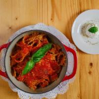 Francobolli · Cheese Ravioli stuffed with fresh ricotta in bolognese sauce and basil.