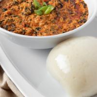 Egusi Soup (Stew) · A stew thickened with African ground melon seeds and contains spinach and pieces of fish and...