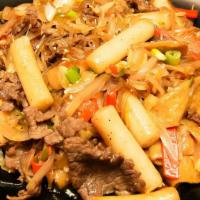 Glass Noodle Toboki · Rice cake stir fried with bulgogi beef, glass noodles, and vegetables.