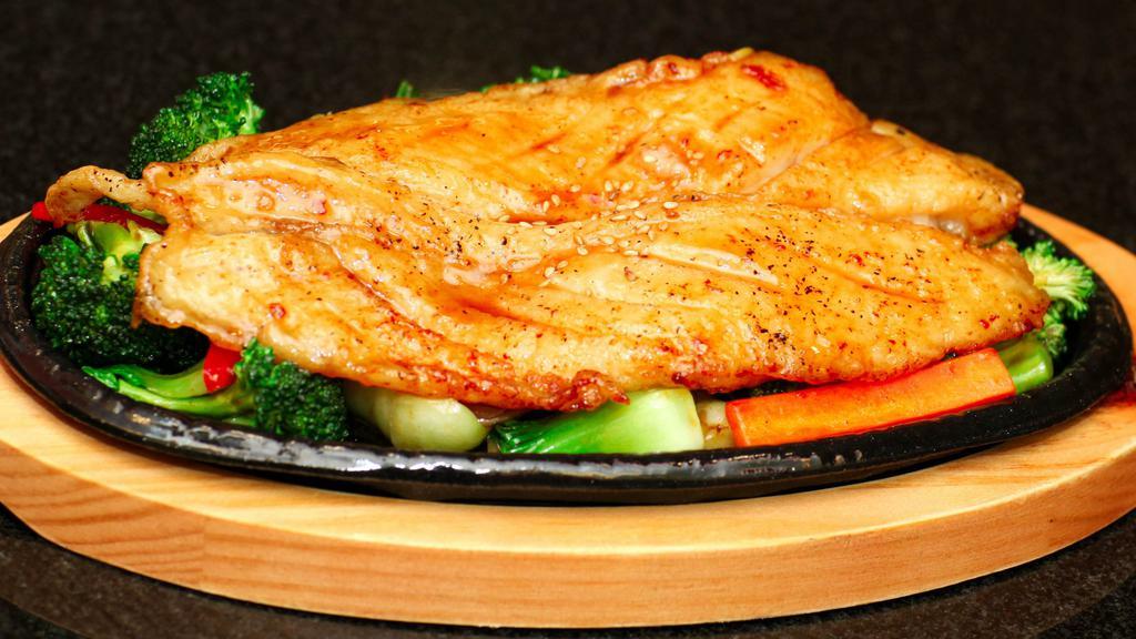 Fish Steak · Grilled boneless fish with stir fried vegetables served with white rice.